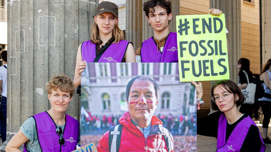 4 Mitarbeiter:innen von Germanwatch mit einem großen Bild von Saúl Luciano Lliuya und einem Schild mit der Aufschrift #End Fossil Fuels